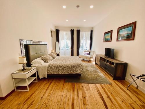 法鲁Casa Saudade luxury rooms的一间卧室配有一张床和一台电视