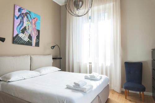 米兰YouHosty - Algardi 5的卧室配有白色的床和蓝色椅子