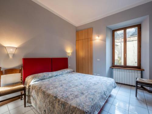 奥尔塔圣朱利奥Apartment Borgo Vecchio by Interhome的卧室配有床、椅子和窗户。