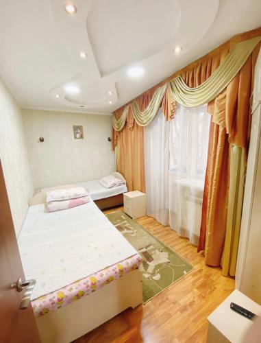 阿拉木图Apartments Ahmetova 6 32的小房间设有两张床和窗户