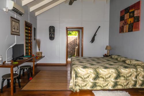 Waiyevo阿鲁哈塔维妮酒店的一间卧室配有一张床、一张桌子和一张书桌