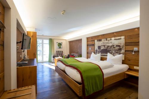 米森-维尔哈姆斯勃劳盖斯夫舍费勒酒店的一间卧室配有一张大床和电视