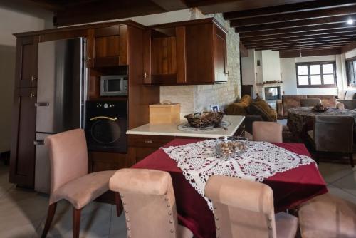 卡尔派尼西翁Kourtis Family Mansion的厨房配有一张桌子,上面有红色的桌布