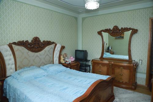 塞凡Norik's Guest House的一间卧室配有一张大床和两面镜子