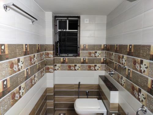 门格洛尔Aikya的一间带卫生间和窗户的浴室