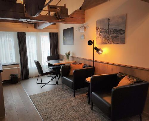 米德尔堡VRYE HEERLYKHEYD ( adults only ) studio 3的带沙发和桌椅的客厅