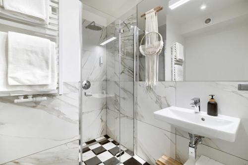 Pakosław帕可斯瓦夫宫酒店的白色的浴室设有水槽和淋浴。