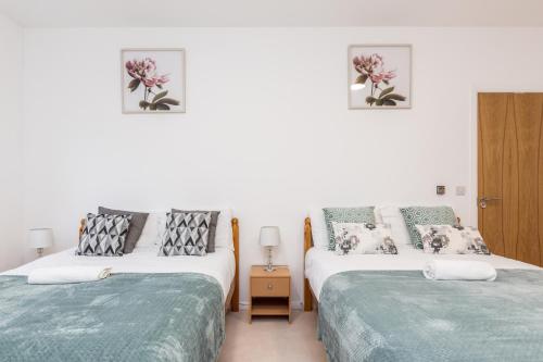 达特福德Lovely 2-Bed Apartment in Dartford的白色墙壁客房的两张床