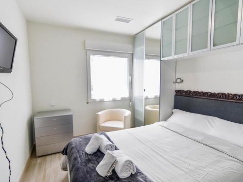 桑坦德Precioso apartamento reformado en el sardinero的一间卧室配有带毛巾的床