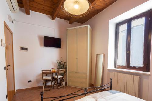 洛雷托Affittacamere Carnevali MJ的一间卧室配有一张床、一张书桌和一个窗户。