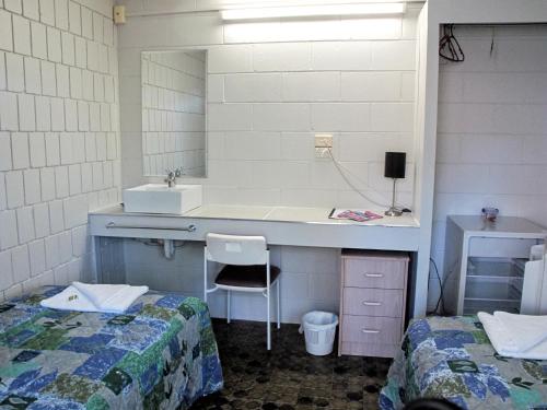 Picnic BayCStay旅舍的一间带水槽的浴室和一张带两张床的书桌
