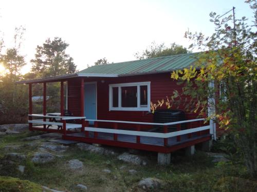 弗格罗Sommarö Stugor的红色的小房子,设有大甲板