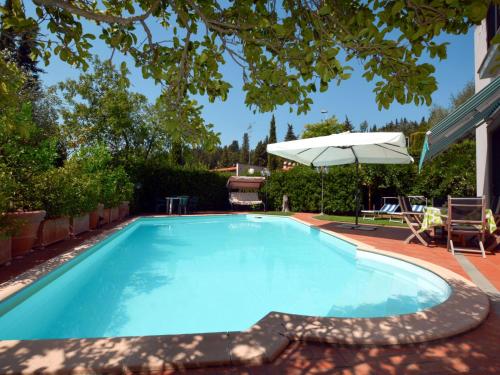 San MartinoHoliday Home Villa Lucia by Interhome的一个带遮阳伞和桌椅的游泳池