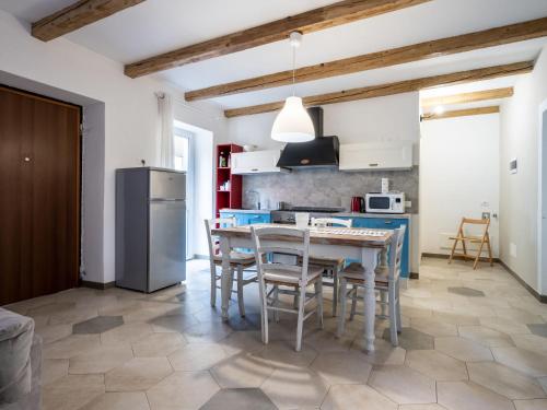 奥梅尼亚Apartment Stella Blu by Interhome的厨房配有桌椅和冰箱。
