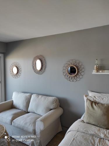 库尔瑟勒·苏尔·梅尔appartement belle vue的客厅配有沙发和墙上的镜子