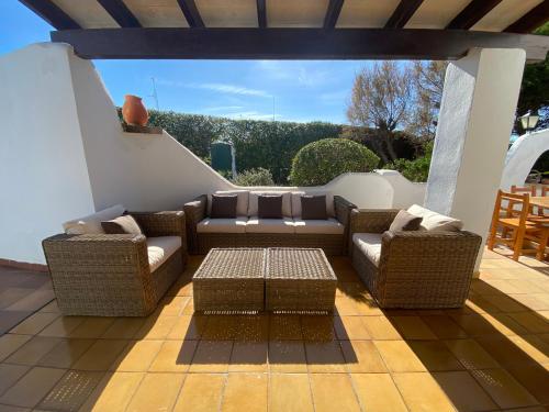 卡兰博希Villa con piscina privada y gran jardín的天井配有2张沙发和1张咖啡桌