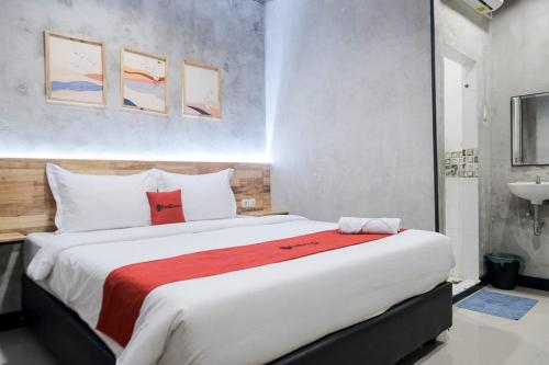 棉兰RedDoorz @ Sekip Medan的一间卧室配有一张带红色毯子的大床