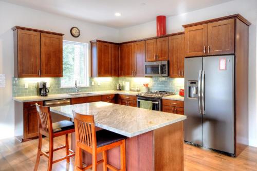 西优胜美地Eureka的厨房配有木制橱柜和不锈钢冰箱。