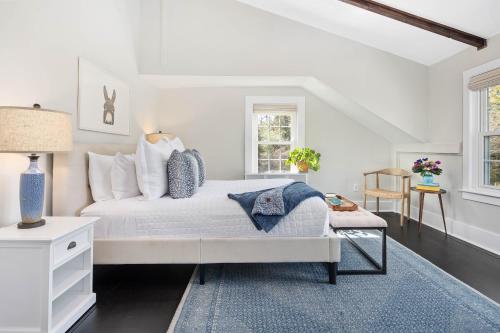 West TisburyLambert's Cove Inn & Resort的白色卧室配有床和蓝色地毯