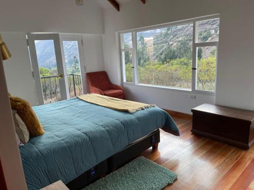 乌鲁班巴AUKA VILLAS BOUTIQUE的一间卧室设有一张床和两个大窗户