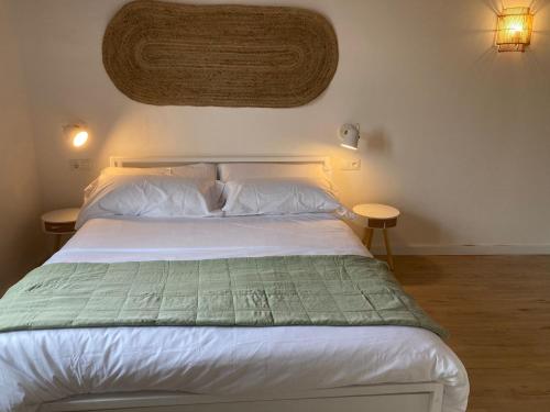 卡内·德·玛尔Can Llavi的卧室配有白色的床和两张桌子