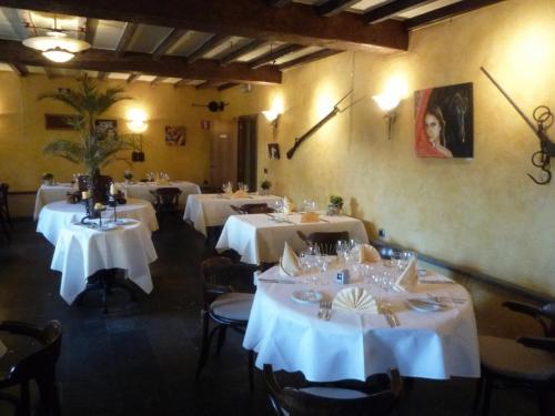 伦德科斯林多斯城堡酒店的用餐室配有带白色桌布的桌子
