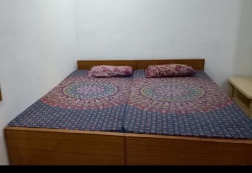 Rāmnagarvinyaka p.g.house的卧室内的一张带两个枕头的床