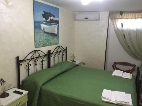 玛丽娜迪曼卡维萨Baccaversa camere的一间卧室配有绿色的床和镜子