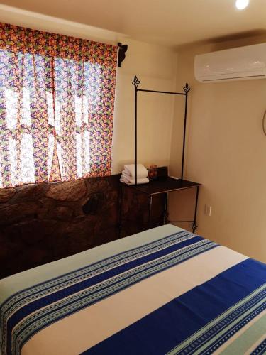 洛雷托La Regional的一间卧室配有一张带镜子的床和窗户