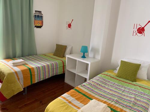 里斯本佩纳旅馆的客房设有两张床和一张带台灯的桌子。