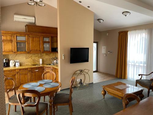 克莱佩达Apartment Senamiesčio Inkaras的厨房以及带桌子和用餐室的起居室。