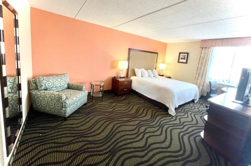 威克利夫法尔布里奇克利夫兰东酒店的配有一张床和一把椅子的酒店客房