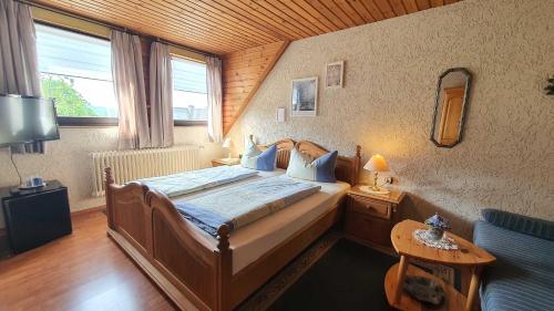 埃伯曼施塔特Hotel Pension Wolf的一间卧室设有一张带木制天花板的大床