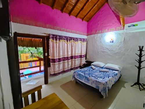 蒙塔尼塔Casa Del Merman at GayMontanita House的卧室配有一张床铺,位于一间粉红色墙壁的房间