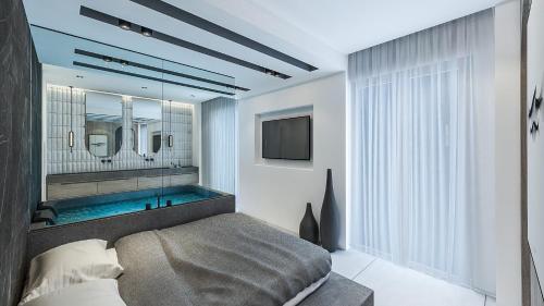 新马尔马拉斯帕帕加罗斯酒店的一间带浴缸、床和电视的卧室