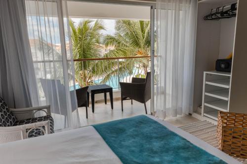 巴亚希贝Hotel Palmera Bayahibe的一间卧室配有一张床,享有海景