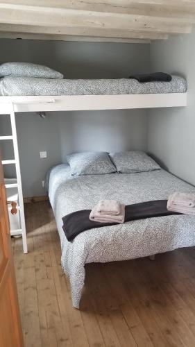 拉图德卡罗勒Maison de montagne的一间卧室配有两张双层床,床上配有毛巾