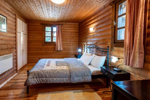 卡尔派尼西翁木屋莱克乌瑞希村公寓式酒店的小木屋内一间卧室,配有一张床