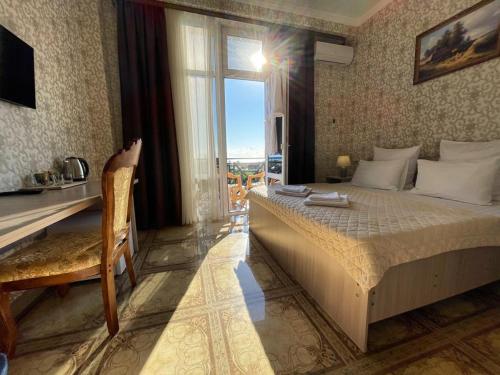 加格拉Отель Империя的一间卧室配有一张床、一张书桌和一个窗户。