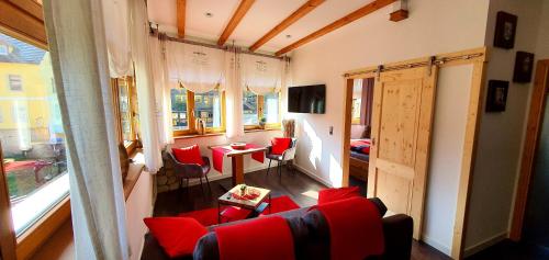 拉特诺Sonniges Eck Ferienwohnung 2的客厅配有红色椅子和桌子