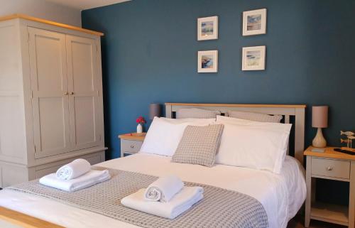 卡比斯贝Stylish coastal retreat in St Ives的一间卧室配有带毛巾的床