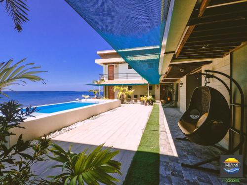 莫龙Miami Heat Beach Resort powered by Cocotel的海边带游泳池的房子