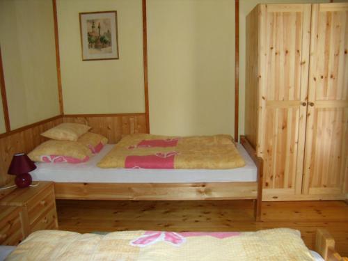 海吉克Hipságh Vendégház的一间卧室配有两张单人床和一个衣柜