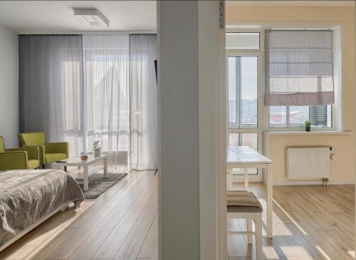 阿斯塔纳Raisson Ahotel D86的卧室配有床、桌子和窗户。