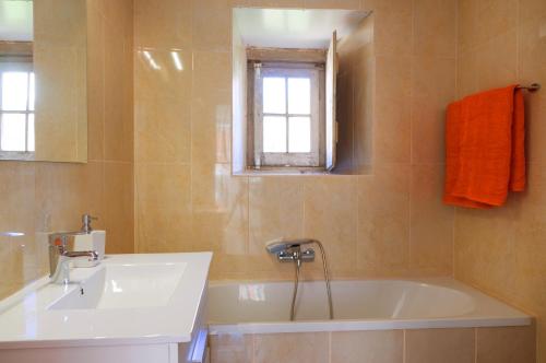 里斯本卡尔尼德度假屋的带浴缸、水槽和窗户的浴室