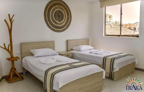 Hotel Iraka Zenu客房内的一张或多张床位