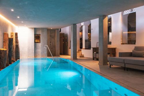 圣安东阿尔贝格西姆尔霍夫酒店的带沙发的房间内的大型游泳池