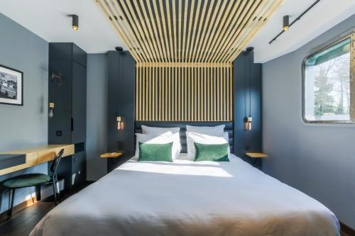 默兹河畔凡尔登Savy Hôtel的一间卧室设有一张带木制天花板的大床