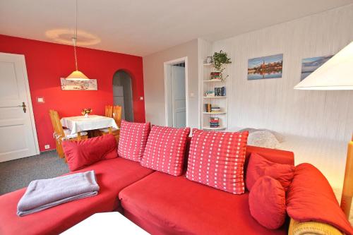 马尔肖Ferienhaus Malchow SEE 7751的客厅里红色的沙发,配有红色枕头
