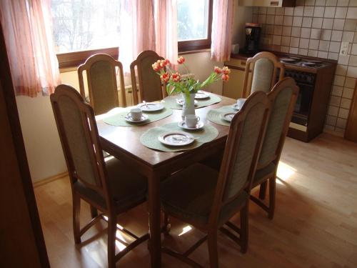 DombühlHaus Reif的餐桌和椅子,鲜花盛开